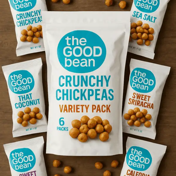 A variety pack of The Good Bean Crunchy Chickpeas on a wooden surface, surrounded by six colorful flavor bags and scattered roasted chickpeas.